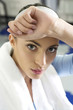 Woman wiping sweat from her forehead