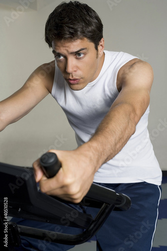 Photo: Man sitting on exercise bike Man sitting on exercise bike