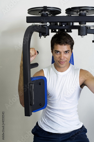 Photo: Man using gym equipment Man using gym equipment