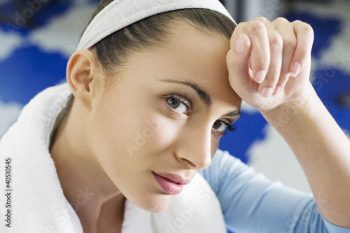 Photo: Woman wiping sweat from her forehead Woman wiping sweat from her forehead