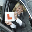 Businessman smiling while holding L plate