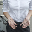 Businesswoman showing grease covered hands