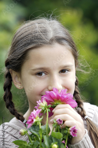 Photo: Girl smelling flowers Girl smelling flowers