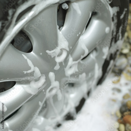 Photo: Car wheel with soap sud Car wheel with soap sud