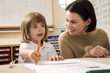 Girl colouring, woman watching