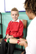 Woman teaching boy how to play the musical instrument