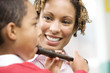 Woman teaching boy to play recorder