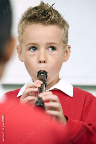 Photo: Boy playing the recorder Boy playing the recorder