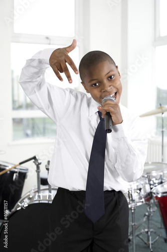 Photo: Boy singing into microphone Boy singing into microphone