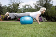 Photo: Senior woman using fitness ball in the park Senior woman using fitness ball in the park