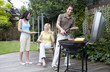Man and women having barbeque in the garden