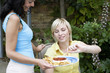 Woman offering her friend some nachos