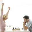 Man and woman playing chess game