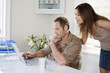 Woman watching man work in a home office