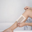 Woman waxing her leg