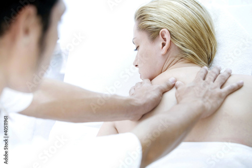 Photo: Massage therapist massaging woman's back Massage therapist massaging woman's back