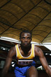 Foto: Man in starting position on running track Man in starting position on running track