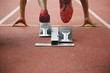 Foto: Man in starting position on running track Man in starting position on running track
