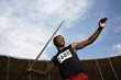 Man throwing javelin in stadium