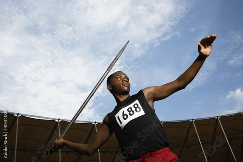 Photo: Man throwing javelin in stadium Man throwing javelin in stadium