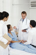 Doctor giving explanation, man holding woman's hands while listening