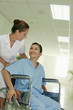 Nurse pushing woman on wheelchair