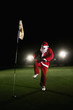 Man in santa suit trying to break a golf club