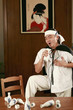 Drunk man singing into sake bottle
