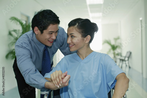 Photo: Woman on wheelchair, man holding her hand Woman on wheelchair, man holding her hand