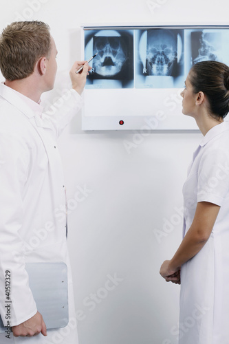 Photo: Doctor explaining to nurse while pointing at X-ray image Doctor explaining to nurse while pointing at X-ray image