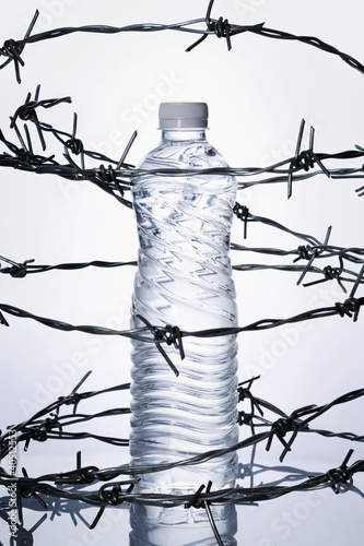 Photo: Plastic bottle surrounded by barbed wire Plastic bottle surrounded by barbed wire