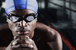 Man with swimming cap and goggles posing for the camera