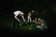 Three men searching for missing golf ball
