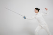 Woman in fencing suit with fencing foil