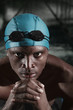 Man with swimming cap and goggles staring at the camera