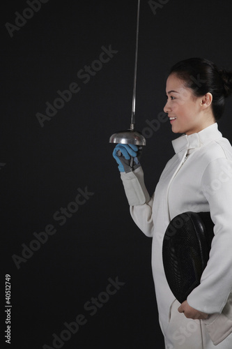 Photo: Woman with fencing foil Woman with fencing foil