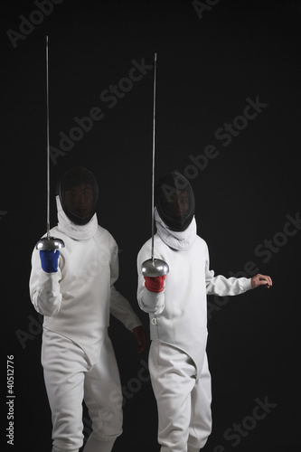 Photo: Two men holding fencing foils Two men holding fencing foils