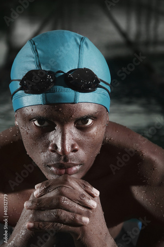 Photo: Man with swimming cap and goggles staring at the camera Man with swimming cap and goggles staring at the camera
