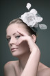 Woman with flower and hat decorating her hair