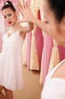Woman in dress posing in front of a mirror