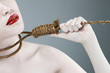 Woman pulling at noose around her neck