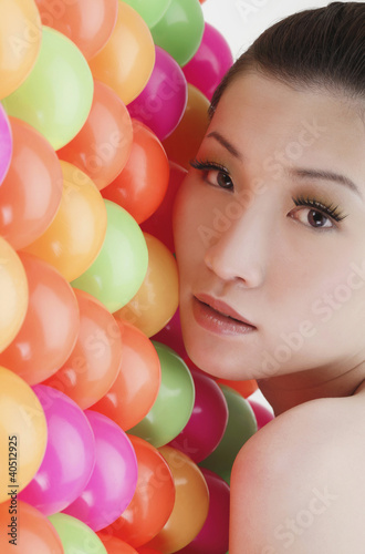 Photo: Woman posing with multi-coloured balls Woman posing with multi-coloured balls
