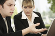 Business people having discussion while using laptop