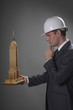 Businessman analyzing model of Empire State Building