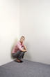 Businesswoman squatting down contemplating