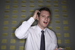 Man scratching his head while holding pen and notepad