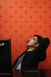 Businessman with hands behind his head