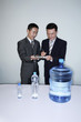 Businessman signing some documents held by his colleague
