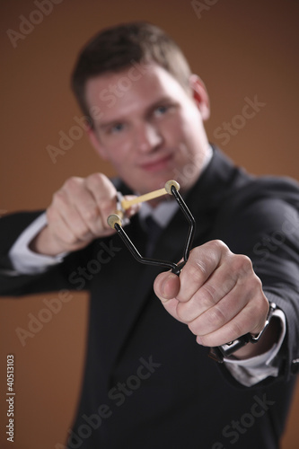 Photo: Businessman using slingshot Businessman using slingshot