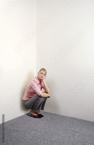 Photo: Businesswoman squatting down contemplating Businesswoman squatting down contemplating